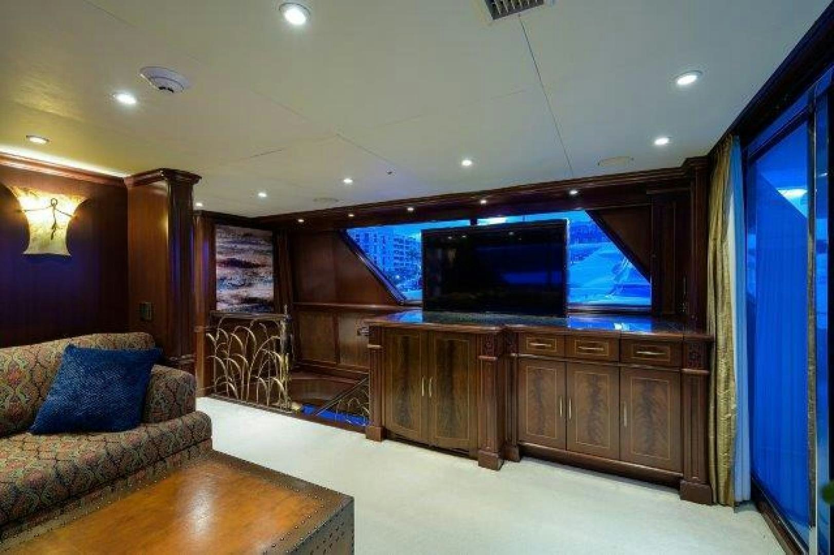 a living room with a large tv aboard UH OH Yacht for Sale