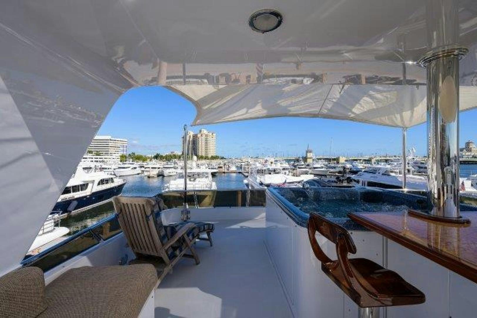 a room with a view of a city and a large blue building aboard UH OH Yacht for Sale