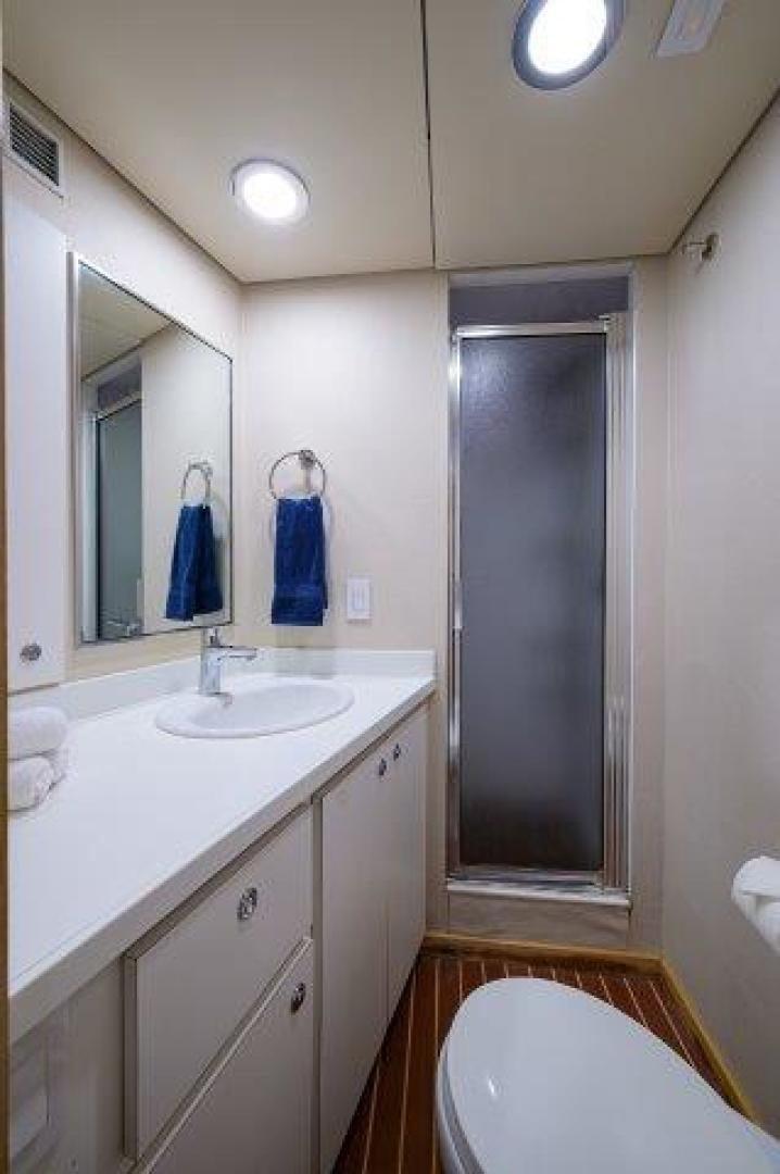 a bathroom with a shower unit and sink aboard UH OH Yacht for Sale