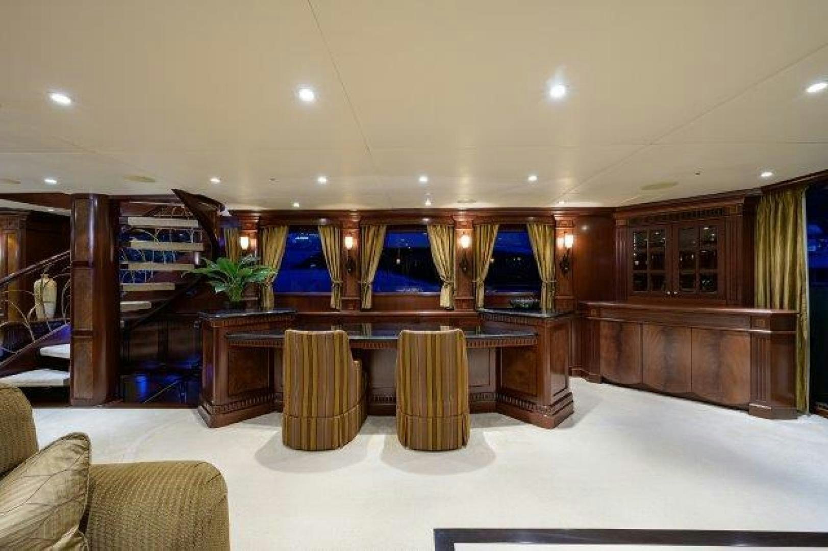 a room with a table and chairs aboard UH OH Yacht for Sale
