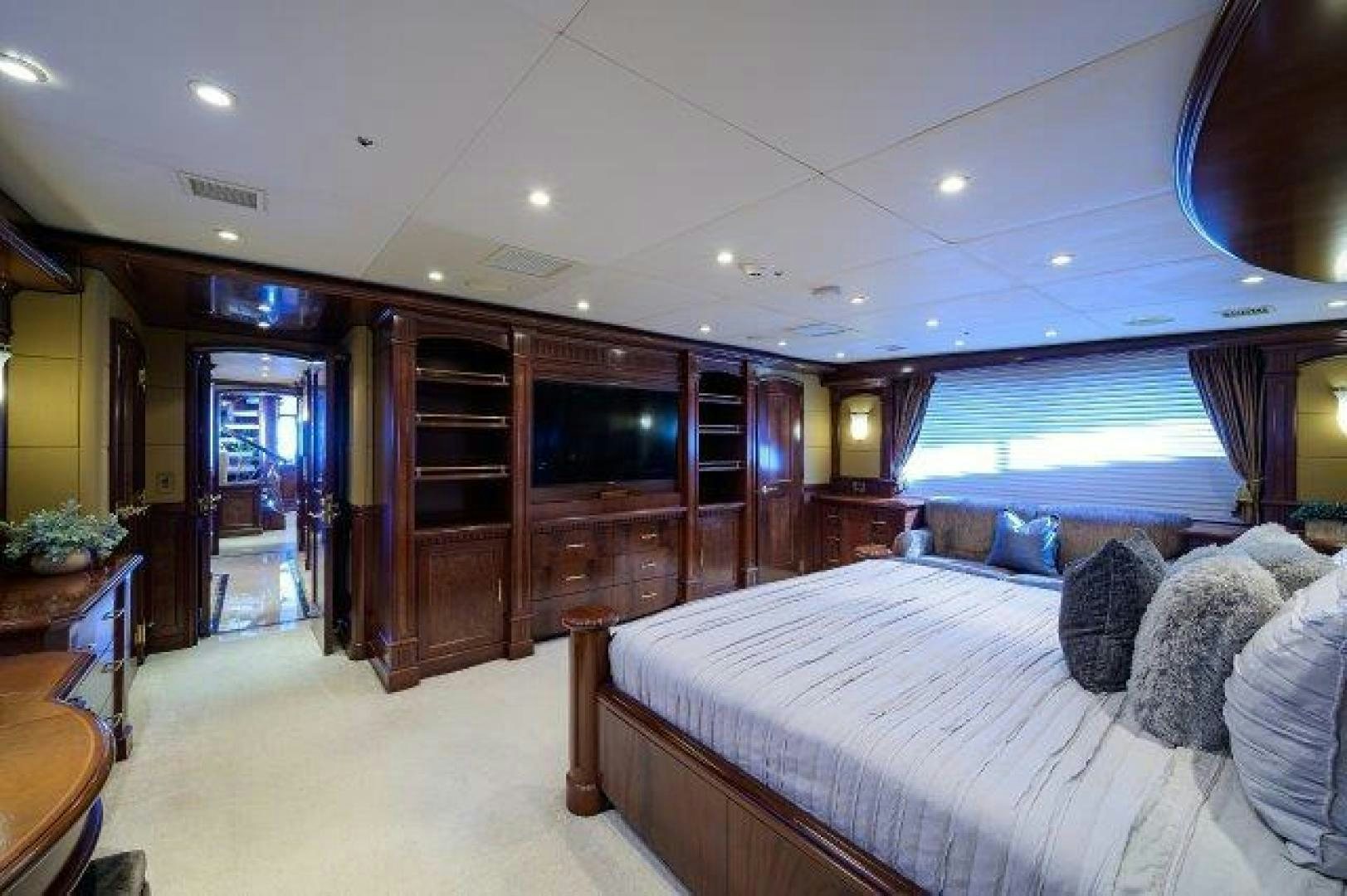 a bedroom with a bed and a television aboard UH OH Yacht for Sale