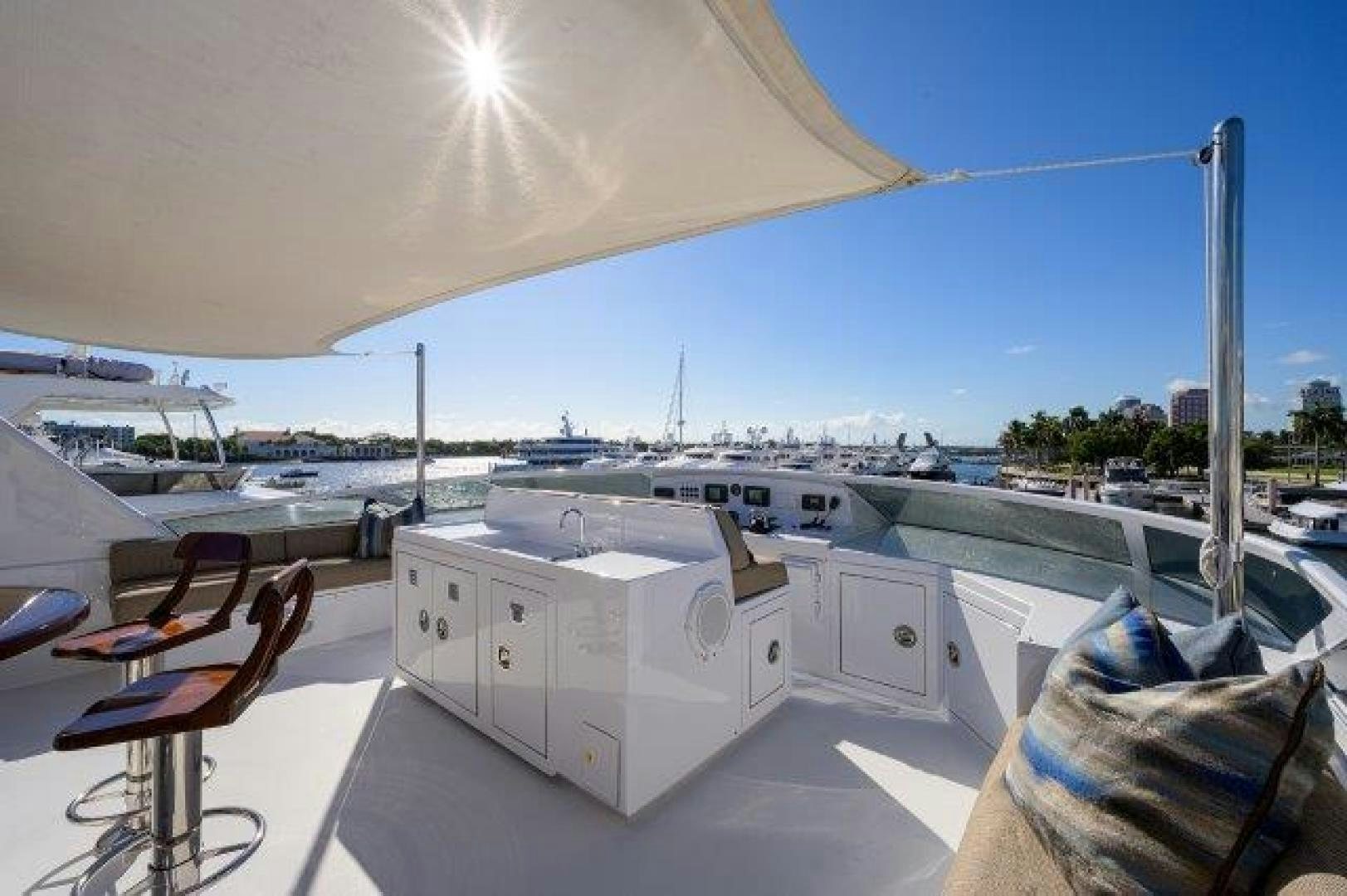 a deck with a deck and chairs aboard UH OH Yacht for Sale