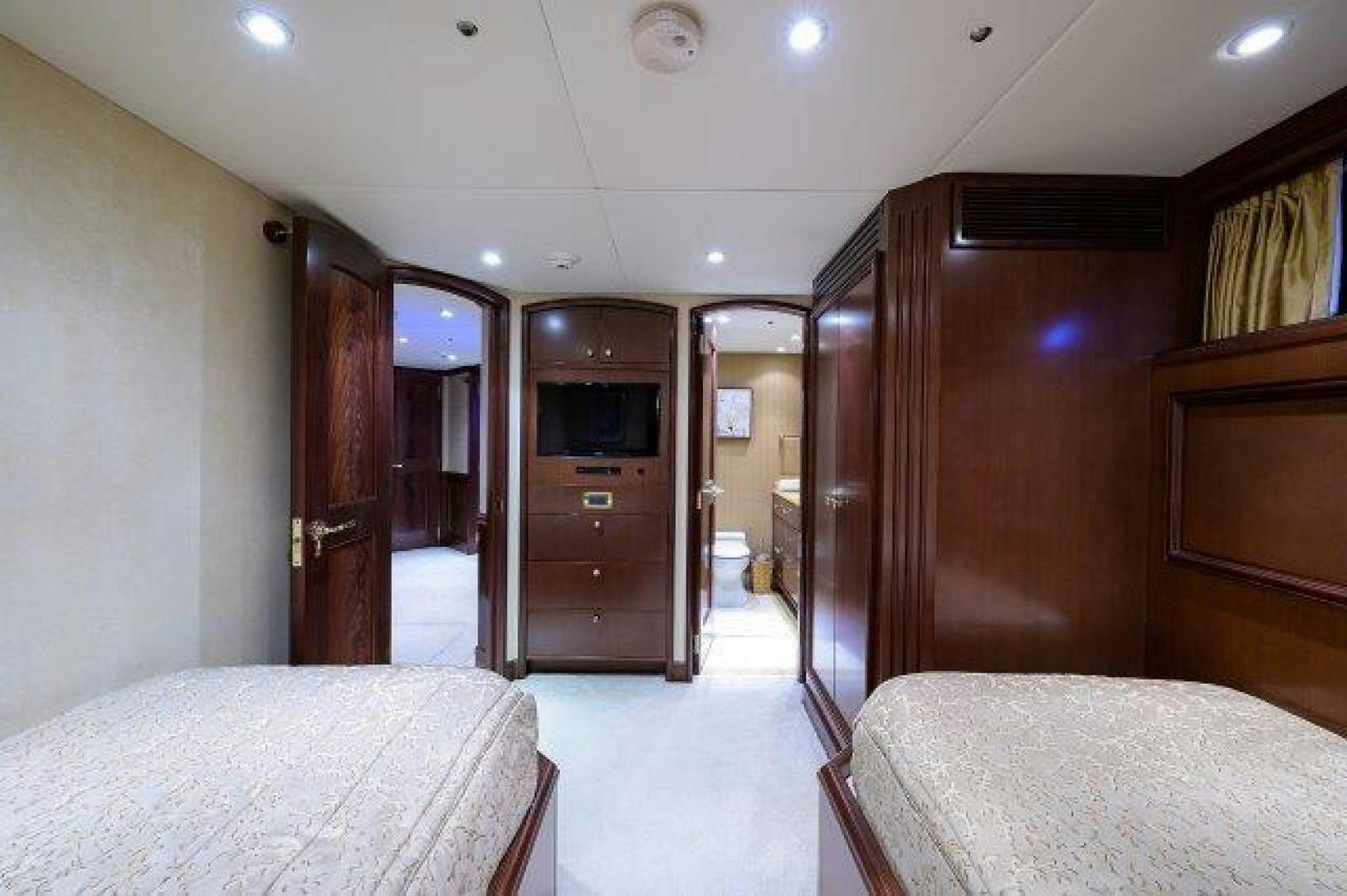 a room with a bed and a television aboard UH OH Yacht for Sale