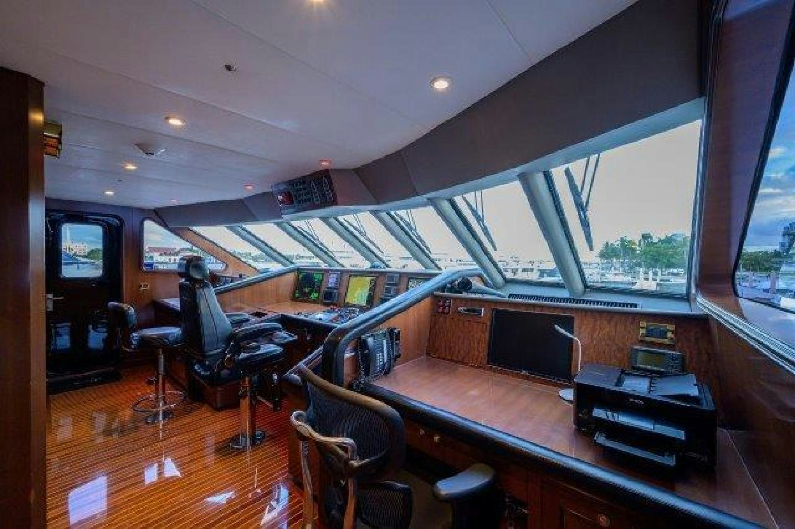 a room with a table and chairs aboard UH OH Yacht for Sale