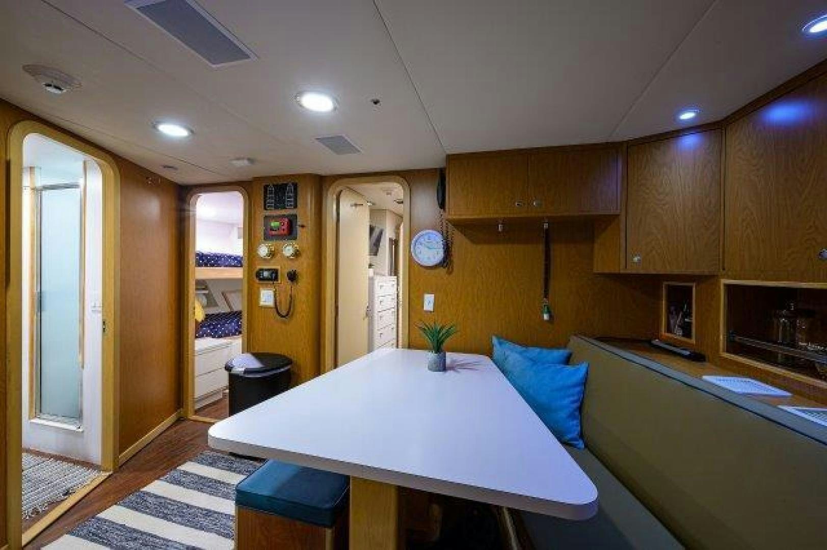 a kitchen with a table and chairs aboard UH OH Yacht for Sale