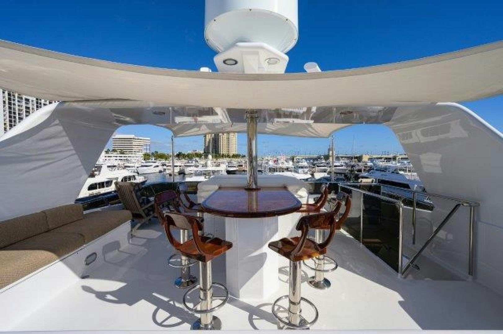 a table and chairs on a deck aboard UH OH Yacht for Sale