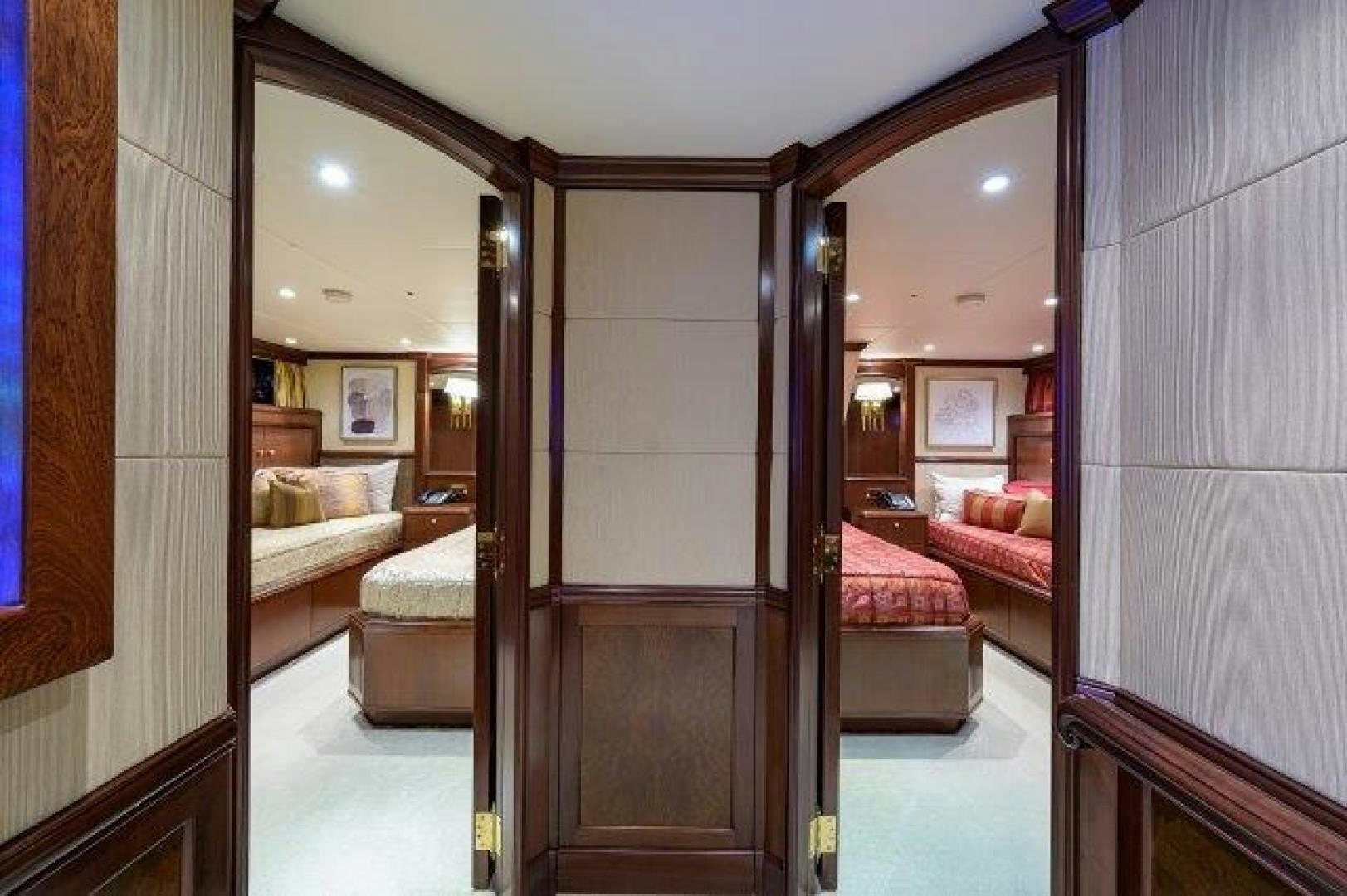 a room with a bed and a mirror aboard UH OH Yacht for Sale