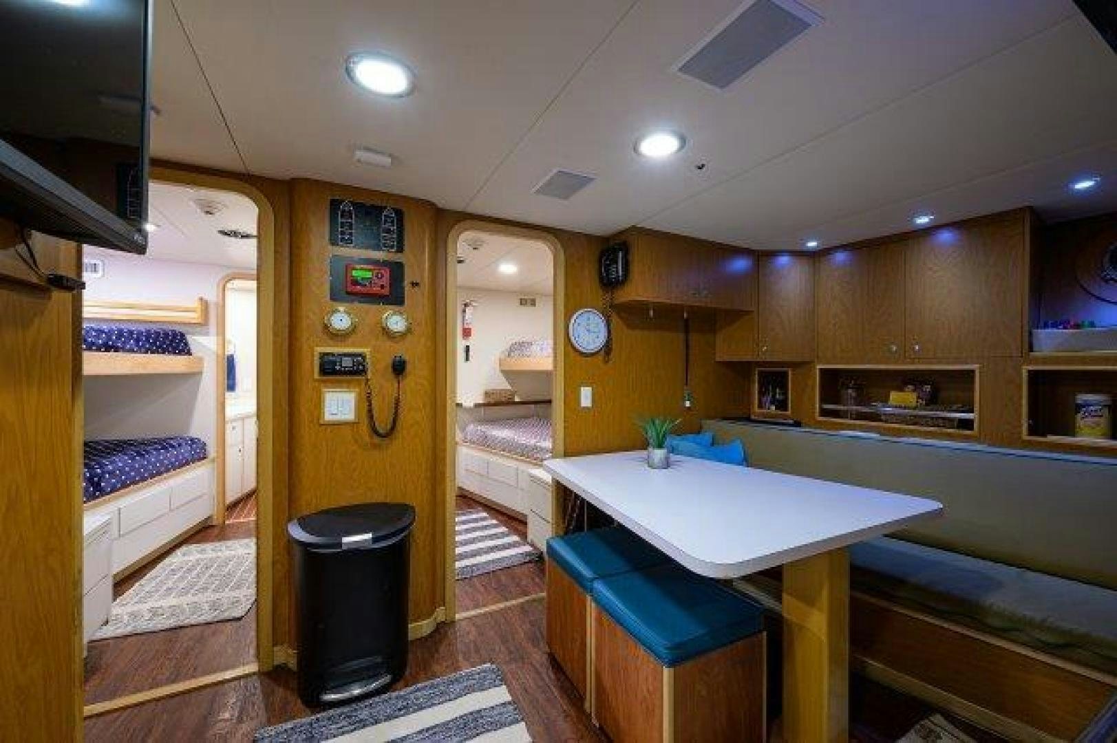 a room with a desk and a bed aboard UH OH Yacht for Sale