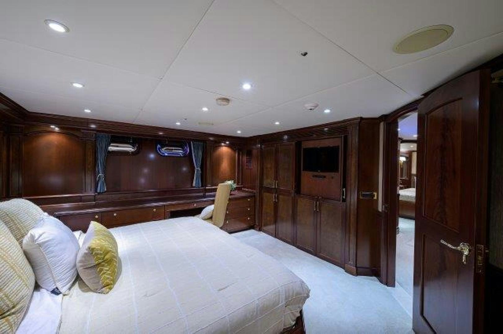 a bedroom with a bed and a closet aboard UH OH Yacht for Sale