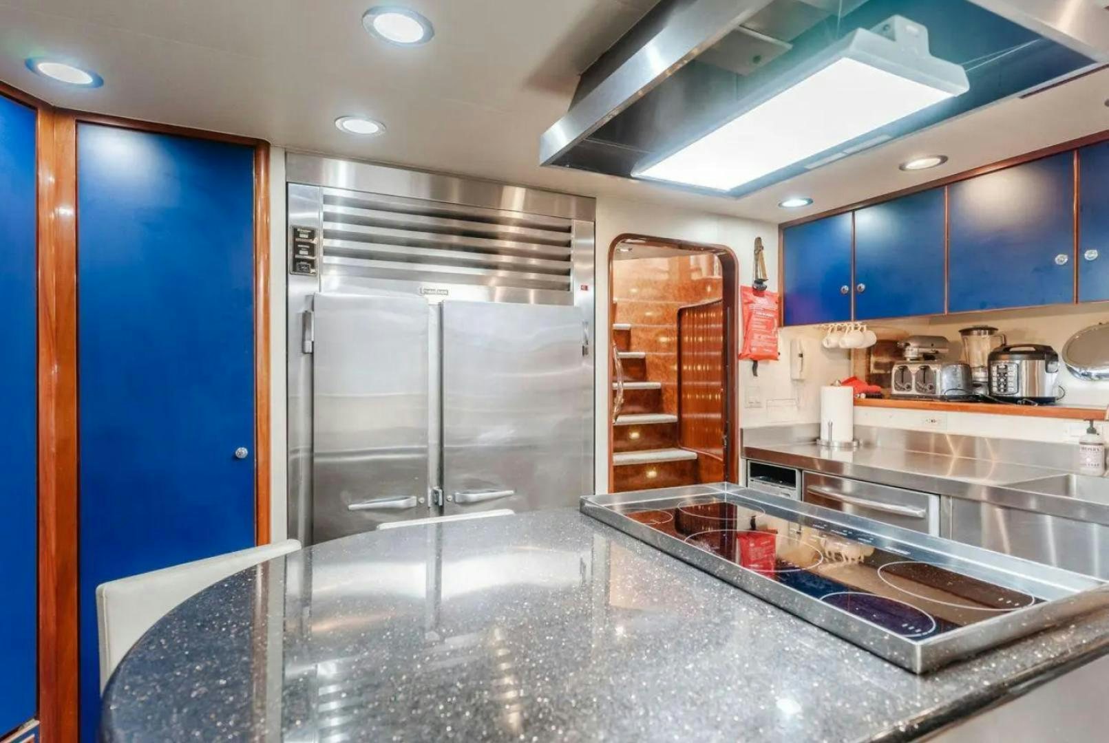 a kitchen with a stainless steel refrigerator aboard MARBELLA Yacht for Sale