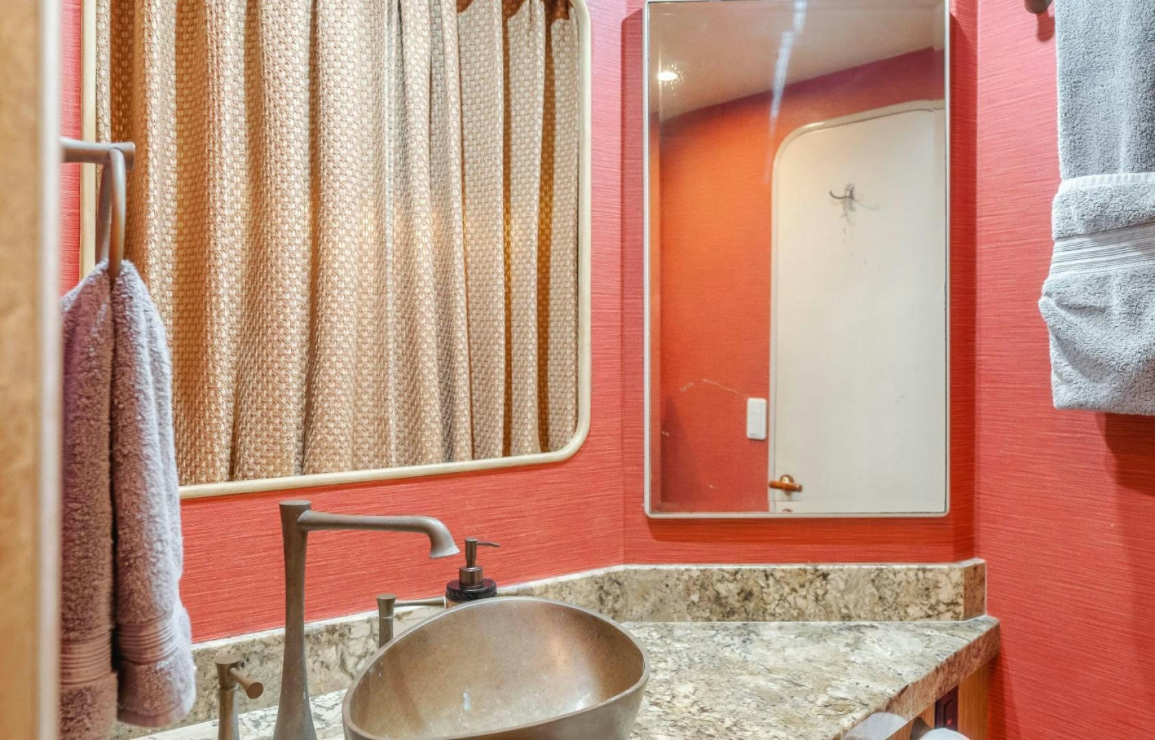 a bathroom with a sink and mirror aboard MARBELLA Yacht for Sale