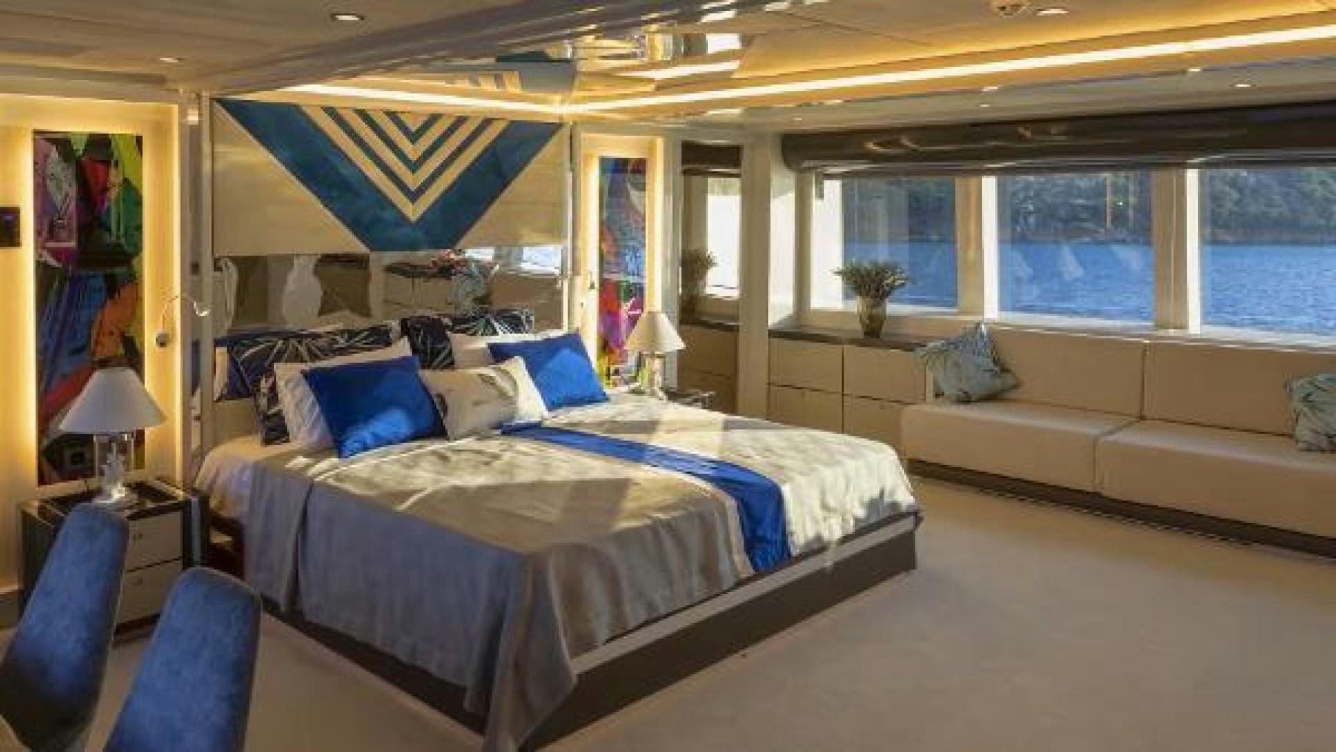 a room with a bed and a couch aboard VETRO Yacht for Sale