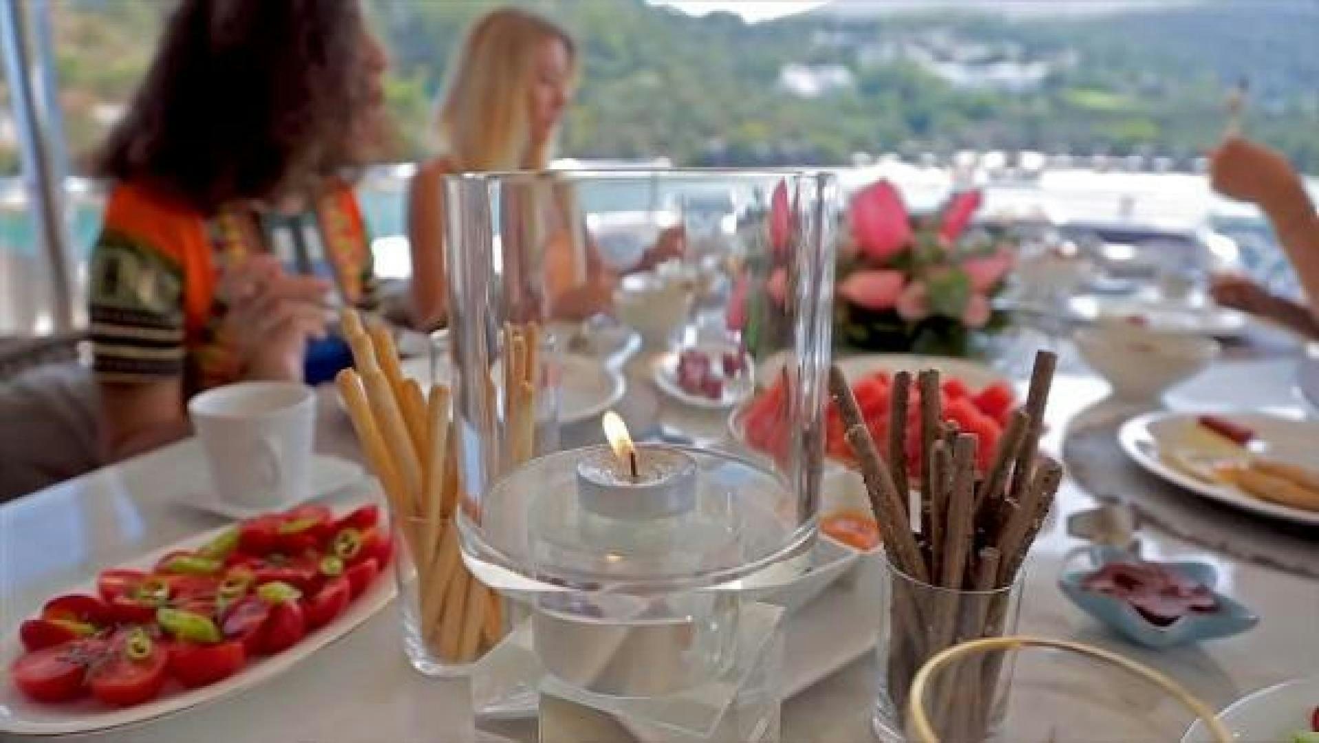 a table with many plates of food aboard VETRO Yacht for Sale