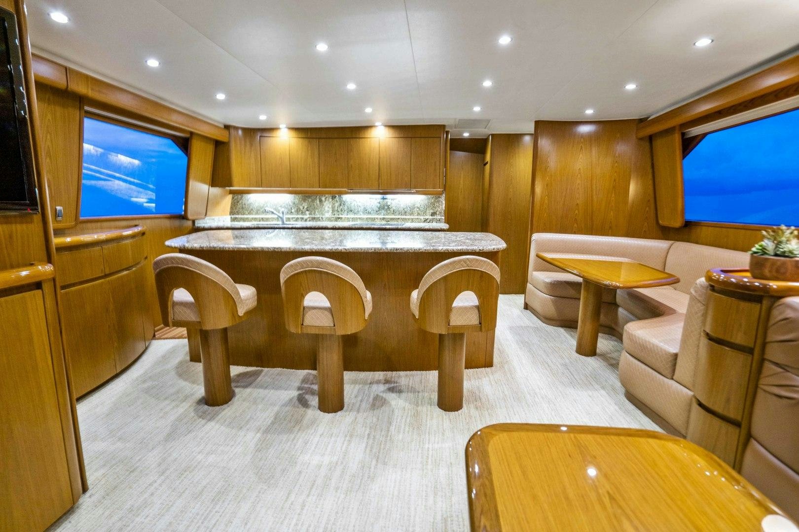 a room with a table and chairs aboard LAST CALL Yacht for Sale
