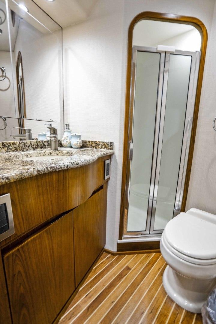 a bathroom with a glass shower door aboard LAST CALL Yacht for Sale