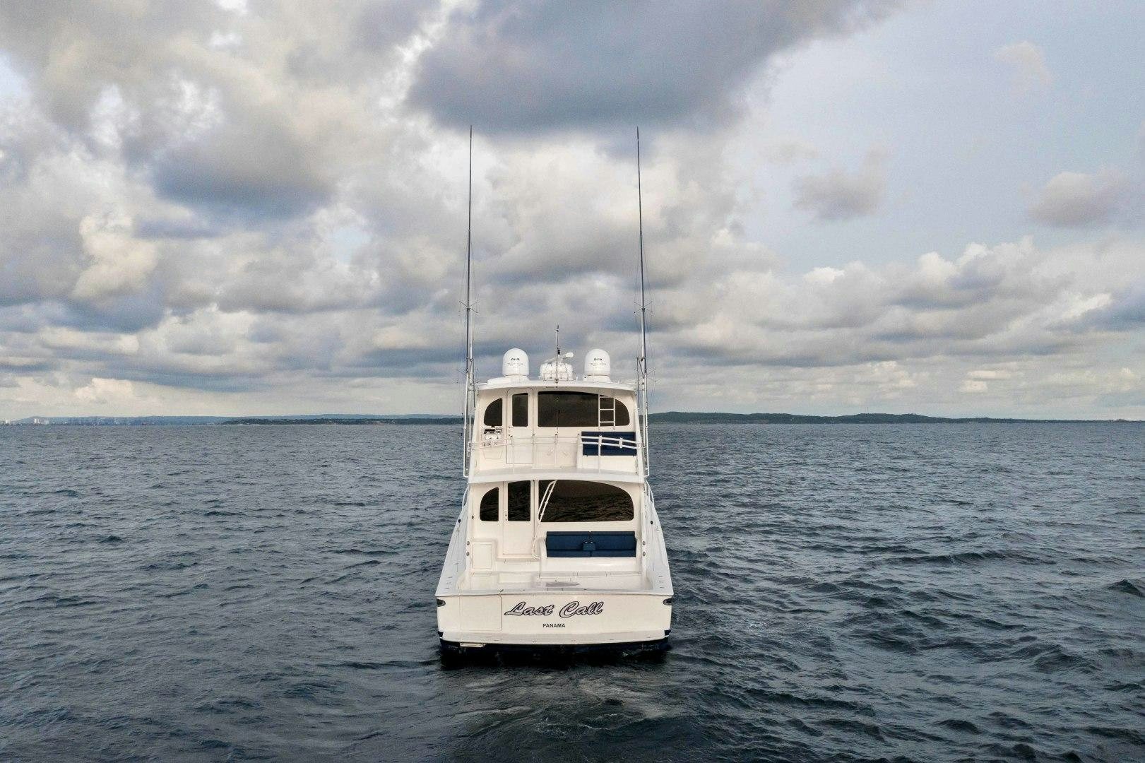 a small white boat in the water aboard LAST CALL Yacht for Sale