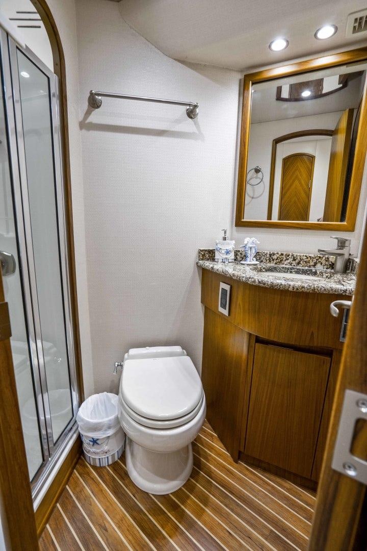 a bathroom with a toilet and a sink aboard LAST CALL Yacht for Sale