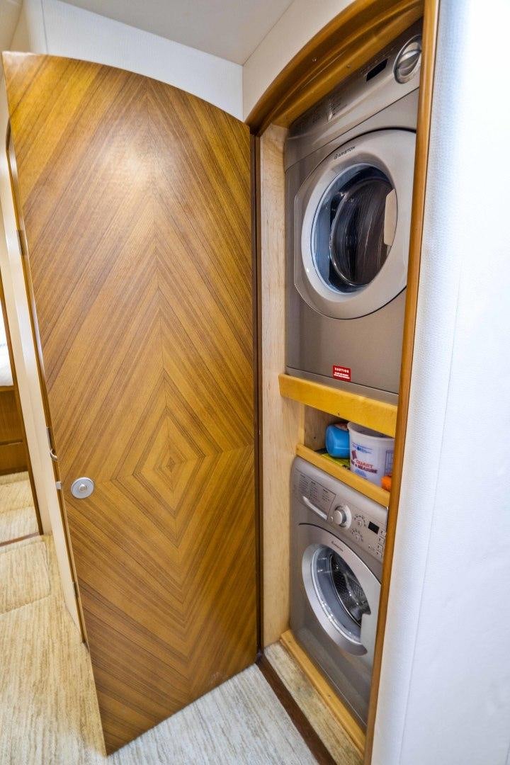 a washer and dryer in a room aboard LAST CALL Yacht for Sale