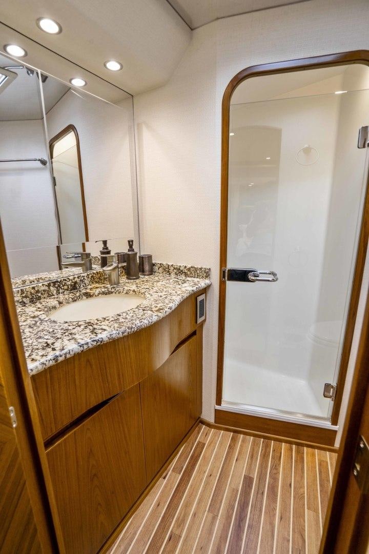 a bathroom with a sink and a shower aboard LAST CALL Yacht for Sale
