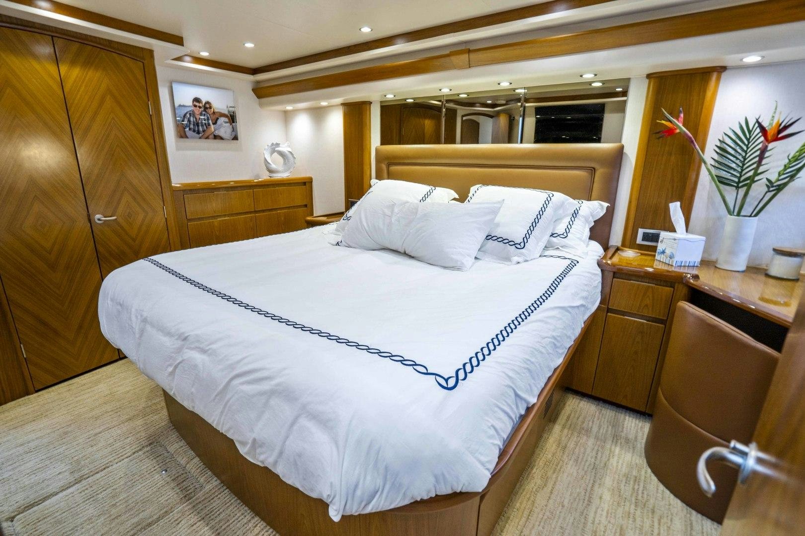a bed with white sheets aboard LAST CALL Yacht for Sale