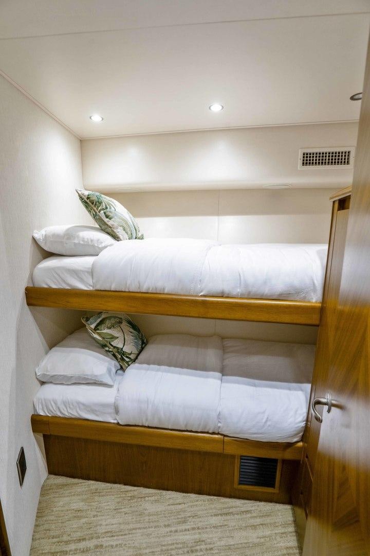 a bed with a wooden frame aboard LAST CALL Yacht for Sale