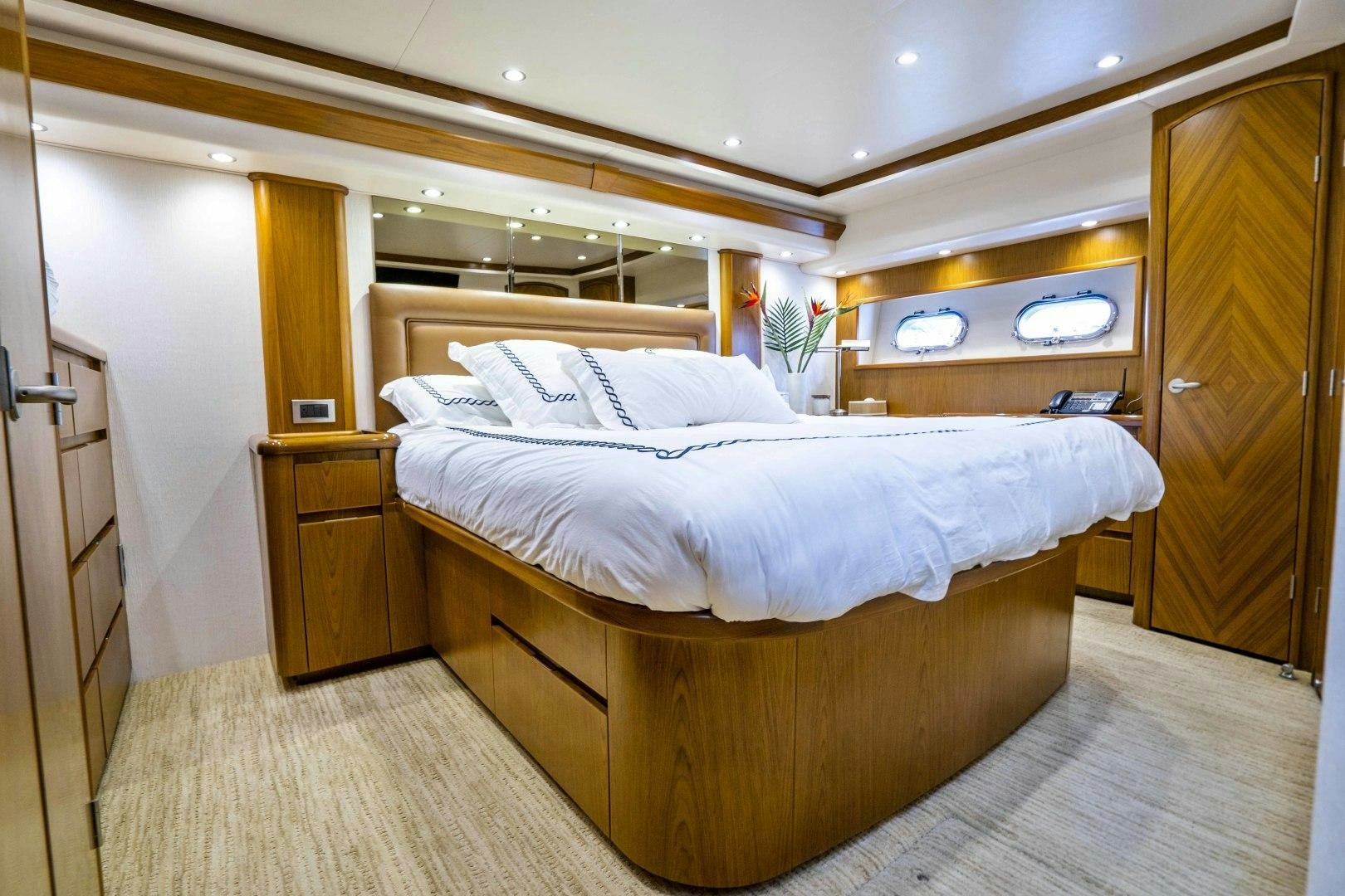 a room with a bed and a closet aboard LAST CALL Yacht for Sale