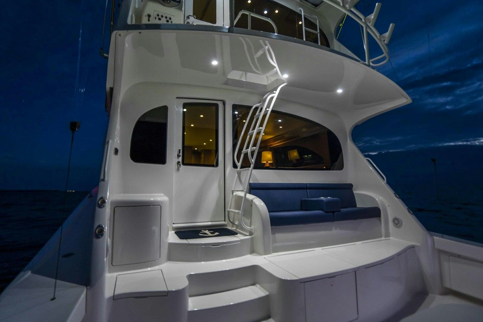 a white boat on a body of water aboard LAST CALL Yacht for Sale