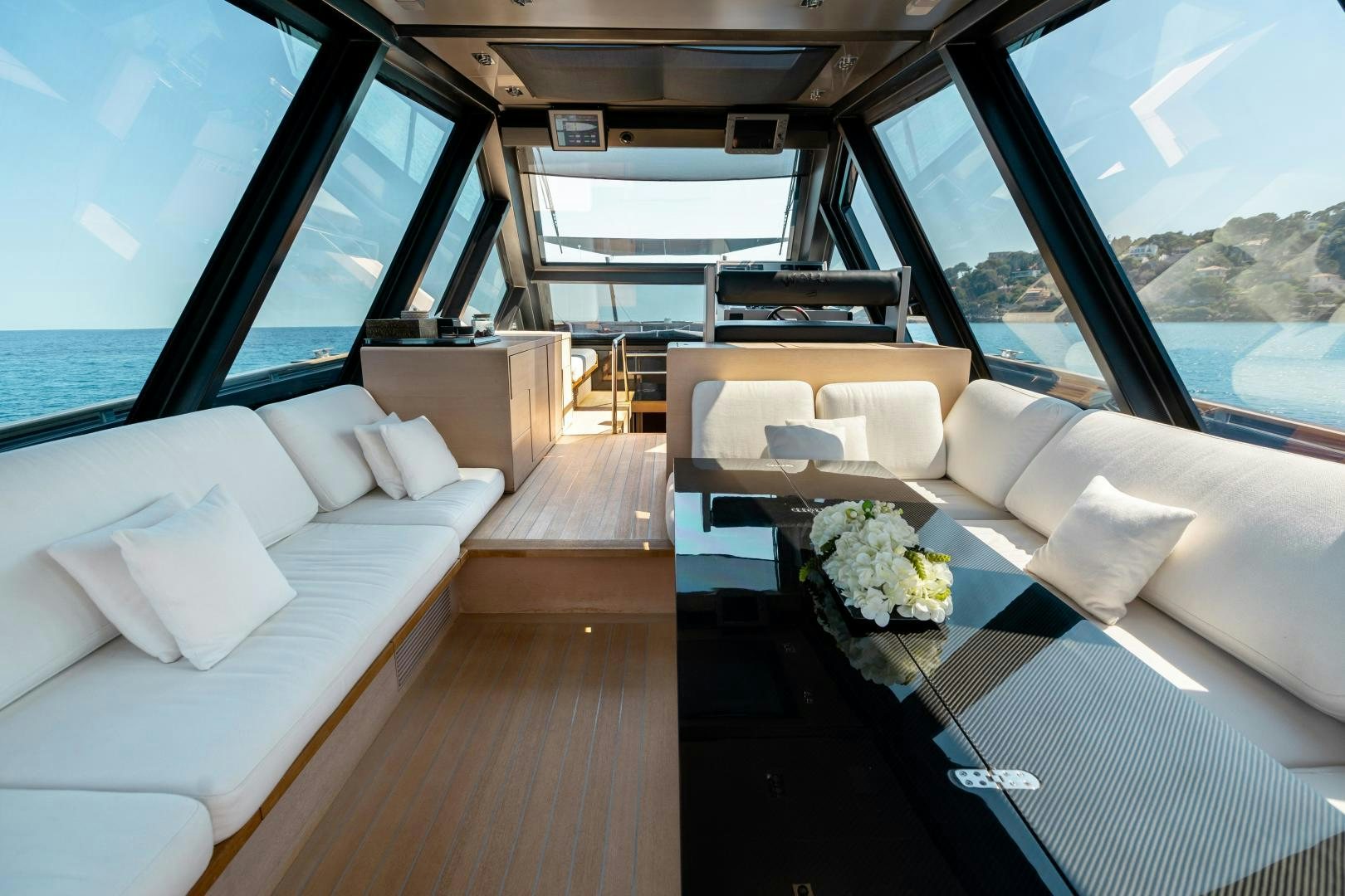 a room with a couch and a table with flowers on it aboard ASH Yacht for Sale