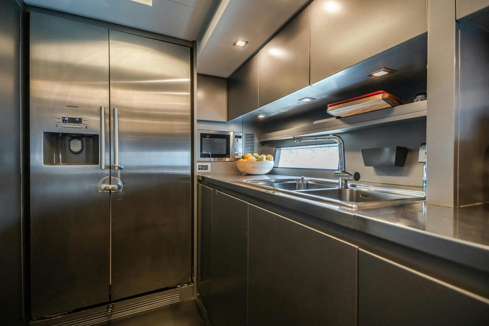 a kitchen with stainless steel appliances aboard ASH Yacht for Sale