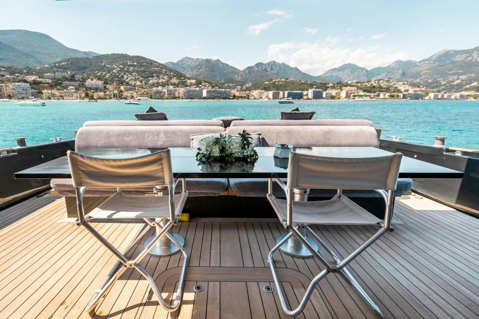 a couple of chairs on a deck overlooking a body of water aboard ASH Yacht for Sale