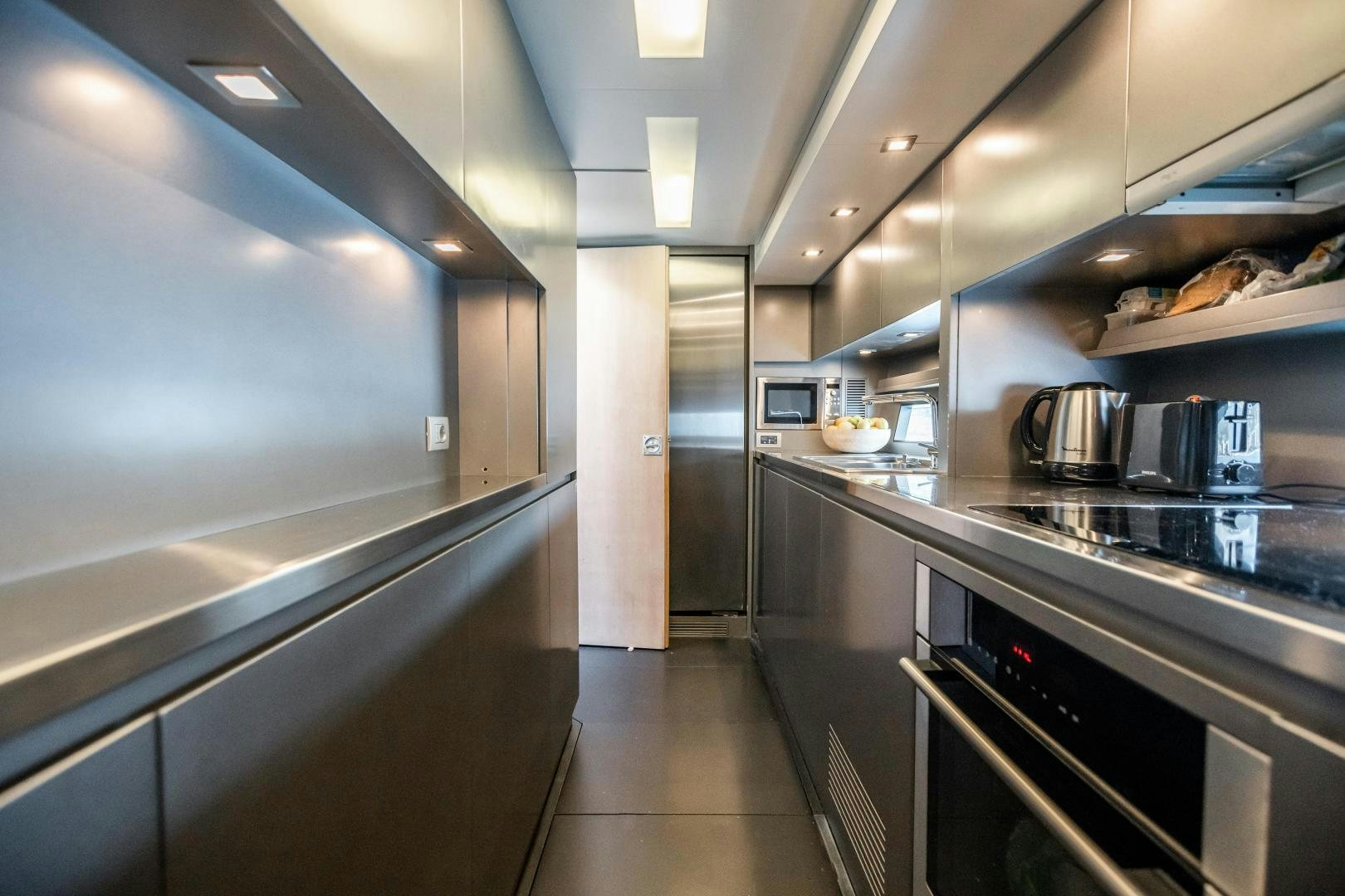 a kitchen with stainless steel appliances aboard ASH Yacht for Sale