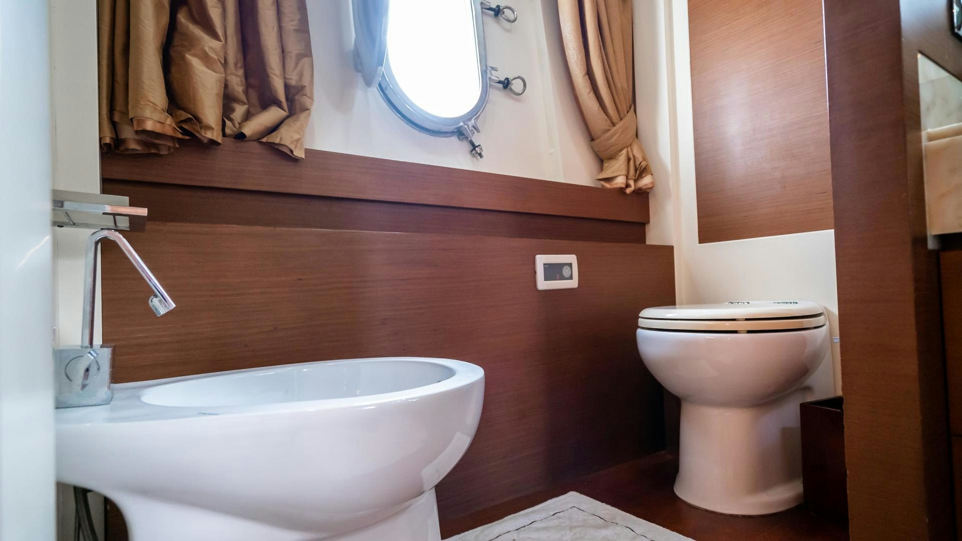 a bathroom with a toilet and a sink aboard CAMY ED Yacht for Sale