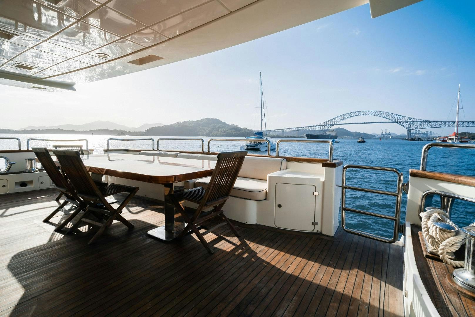 a deck with a table and chairs on it aboard CAMY ED Yacht for Sale