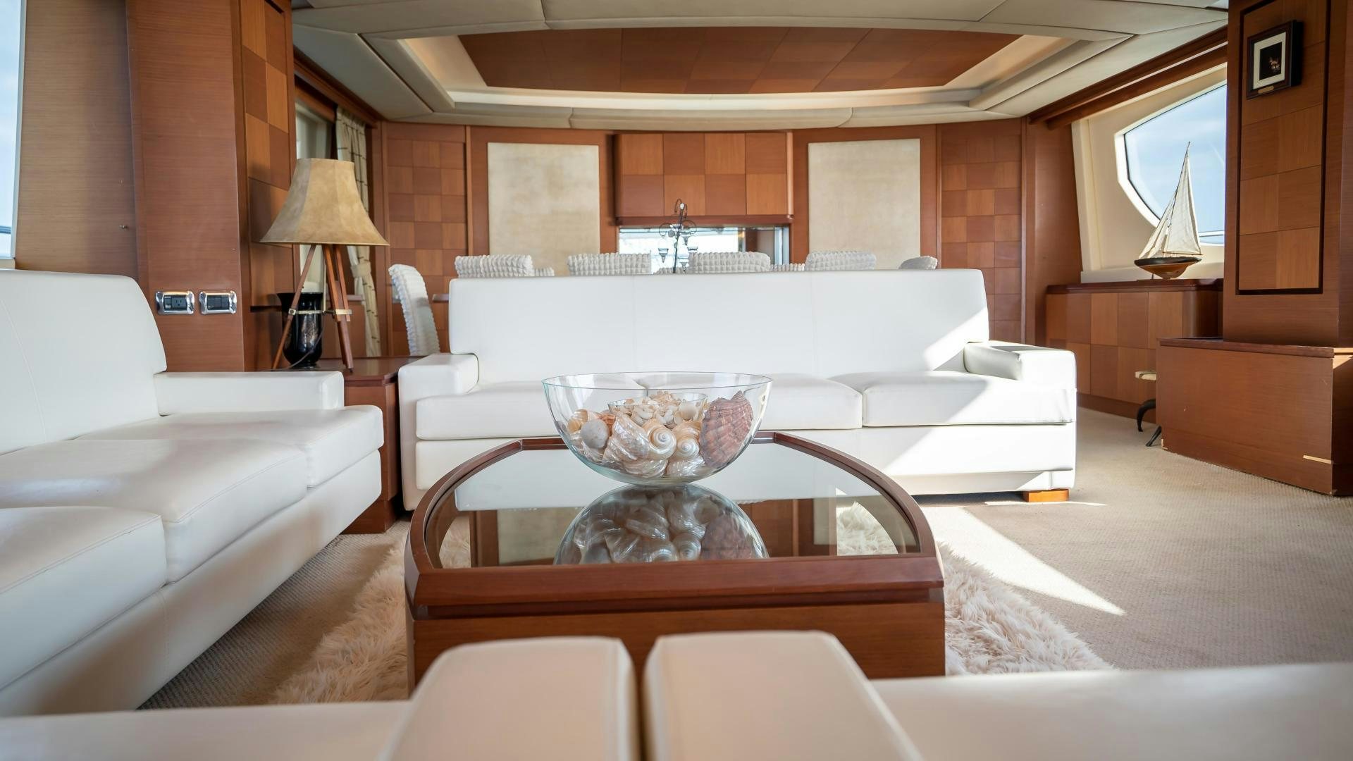 a living room with a large white sofa and a coffee table aboard CAMY ED Yacht for Sale