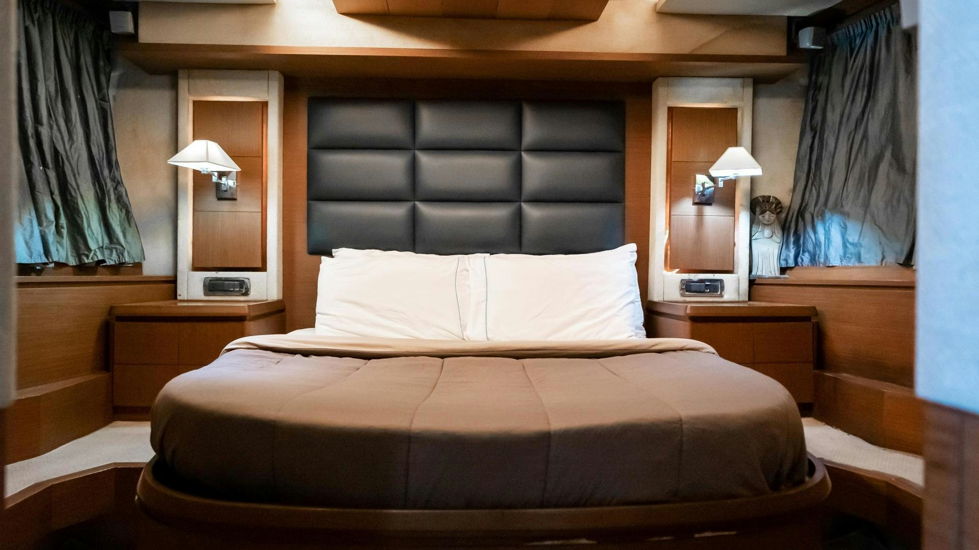 a bed with a black headboard aboard CAMY ED Yacht for Sale