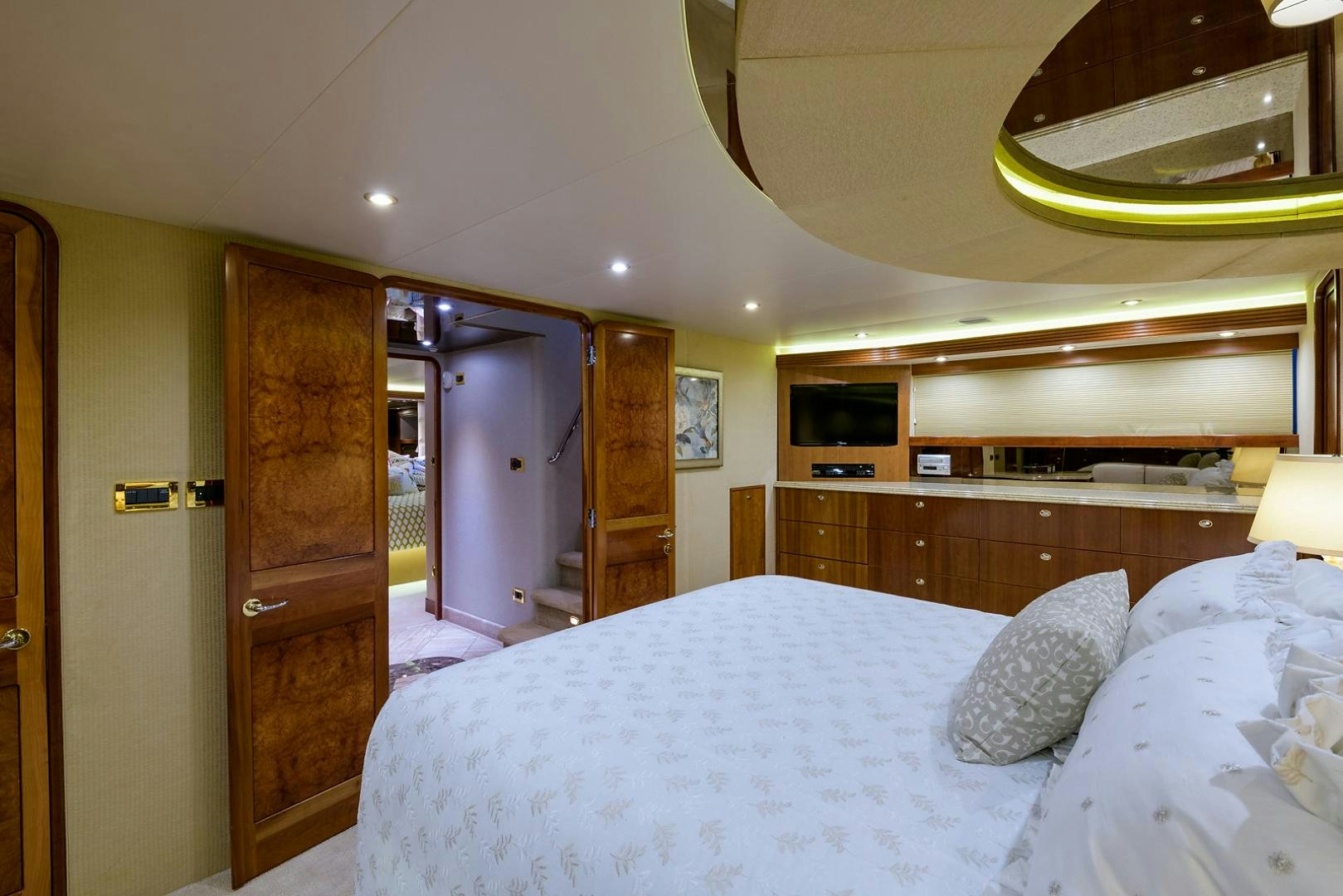 a bedroom with a bed and a wood door aboard MY GIRL Yacht for Sale