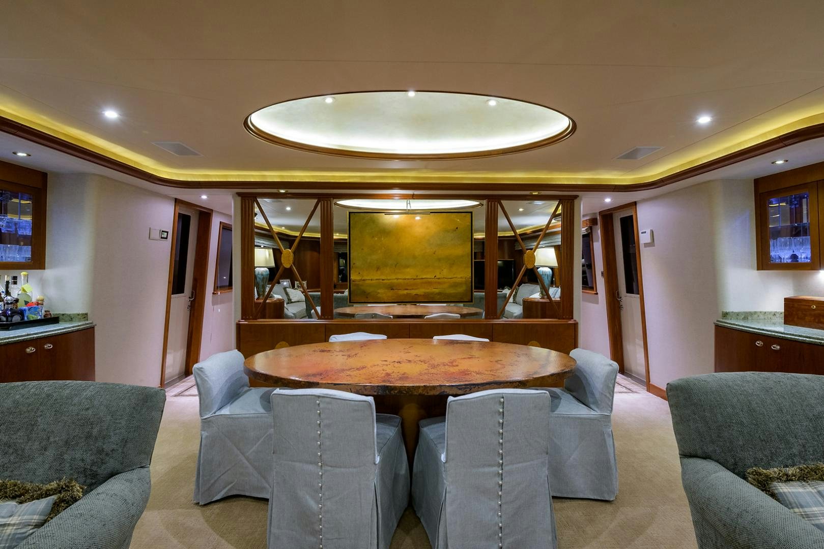a large living room with a round table and chairs aboard MY GIRL Yacht for Sale