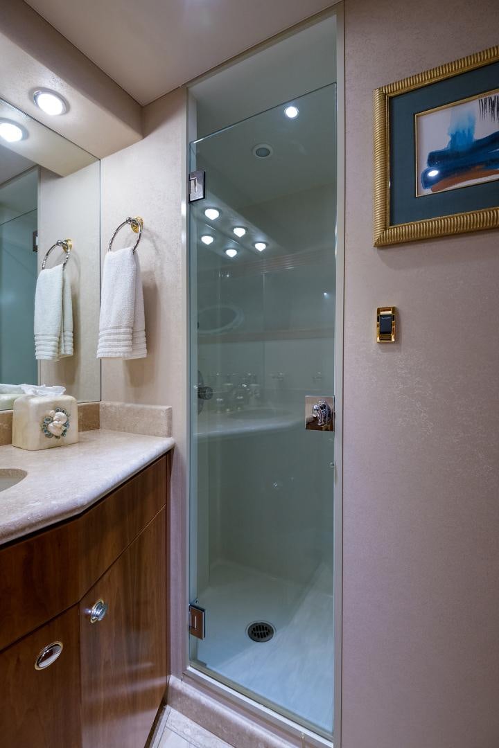 a bathroom with a glass shower door aboard MY GIRL Yacht for Sale