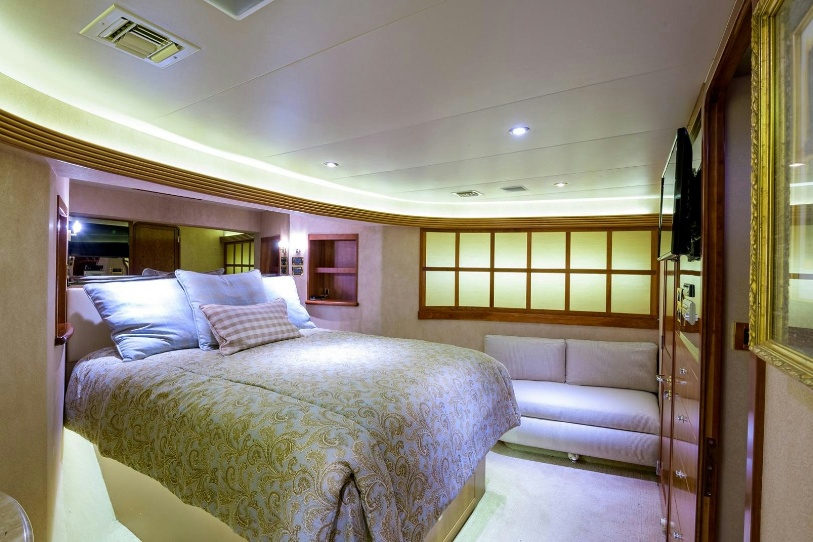 a bedroom with a bed and a couch aboard MY GIRL Yacht for Sale