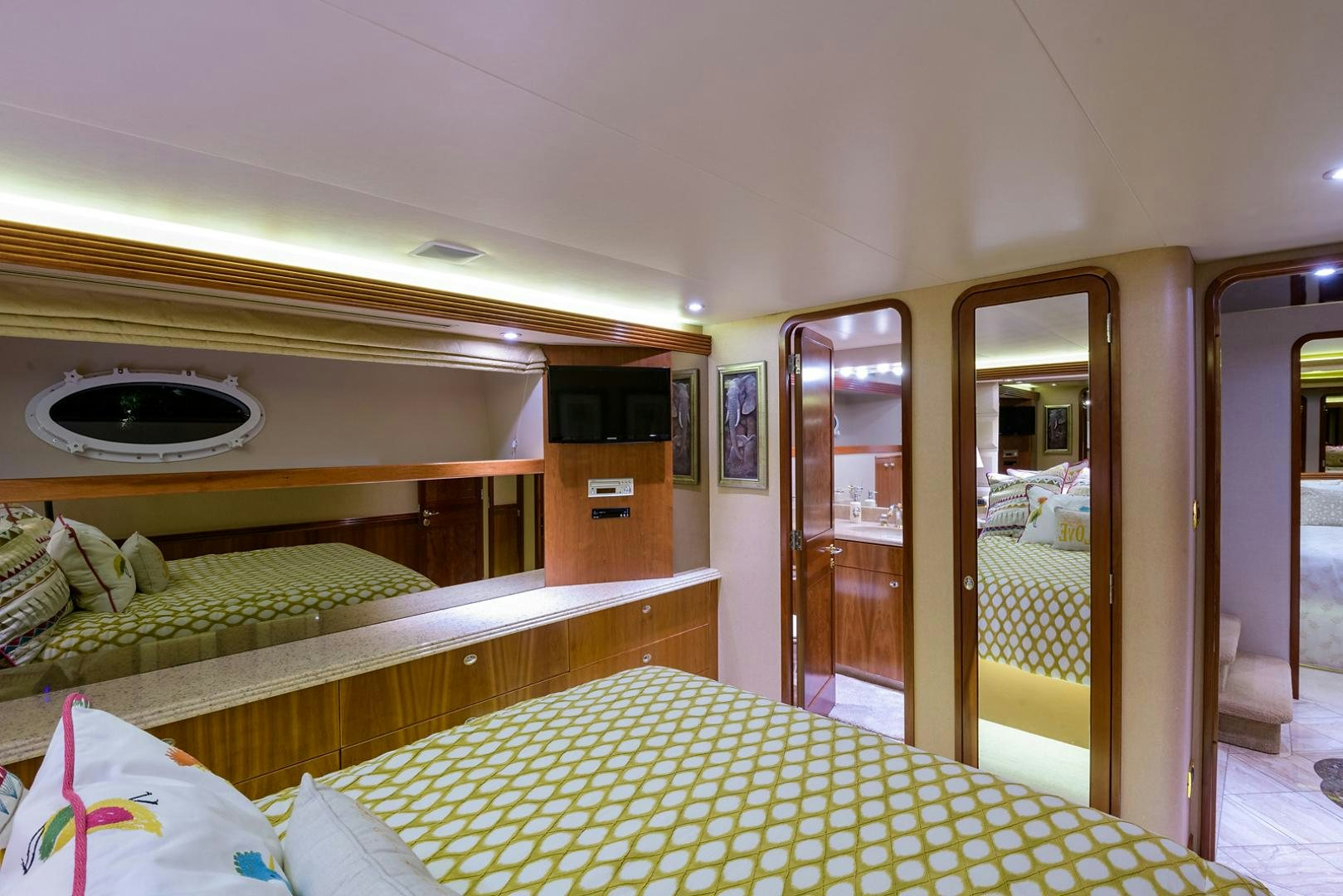 a room with a bed and a mirror aboard MY GIRL Yacht for Sale
