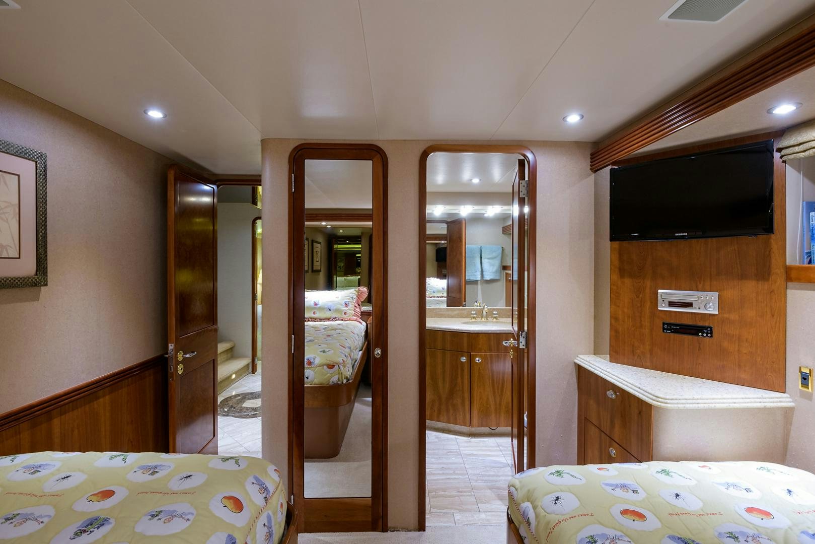 a bedroom with a bed and a mirror aboard MY GIRL Yacht for Sale