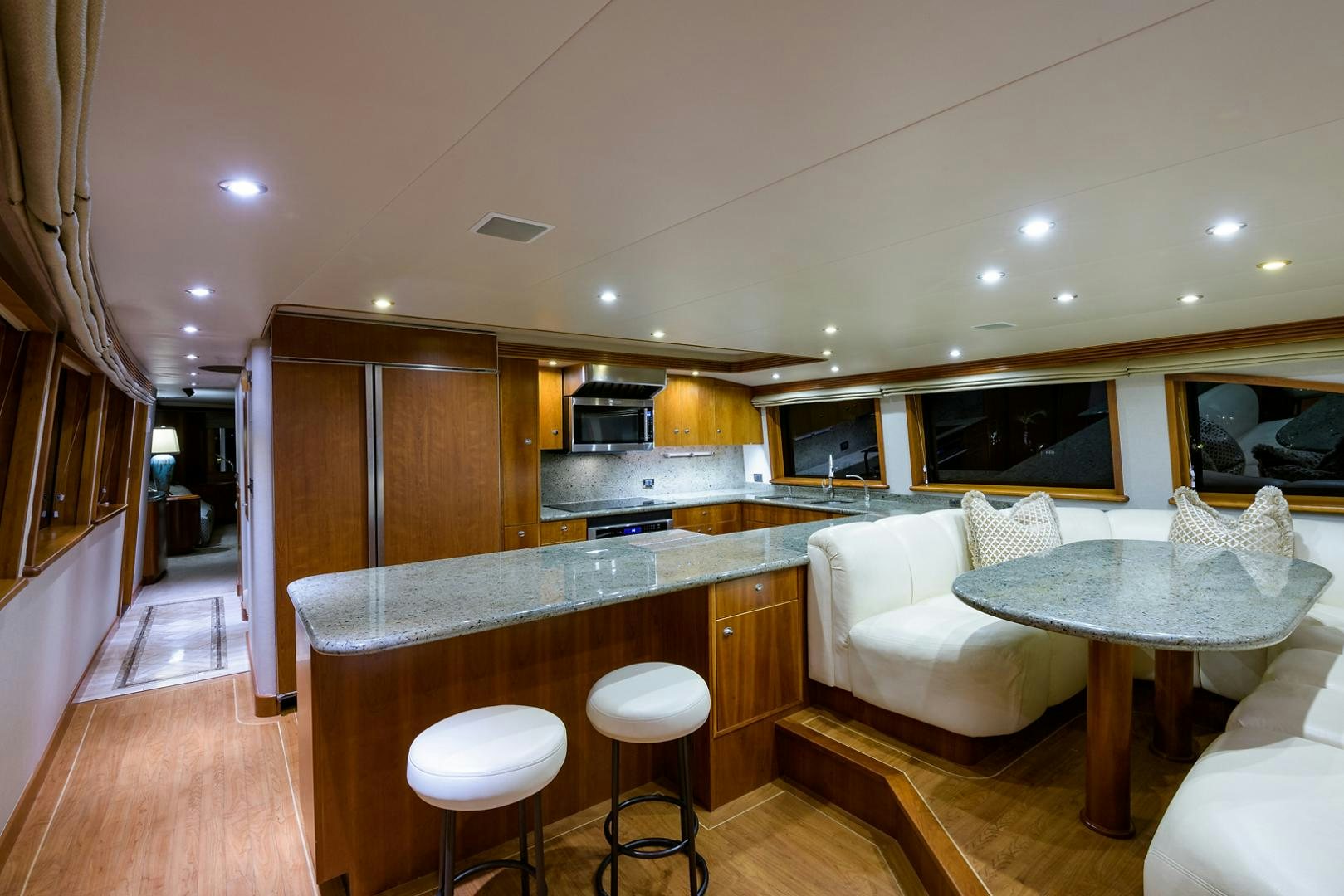 a kitchen with a table and chairs aboard MY GIRL Yacht for Sale