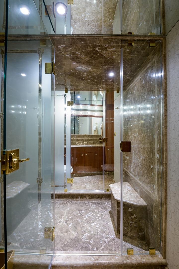 a bathroom with a glass shower aboard MY GIRL Yacht for Sale