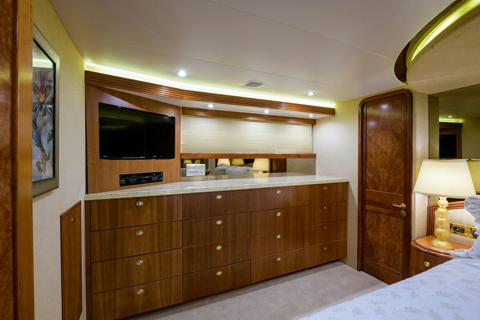 a bedroom with a bed and a television aboard MY GIRL Yacht for Sale