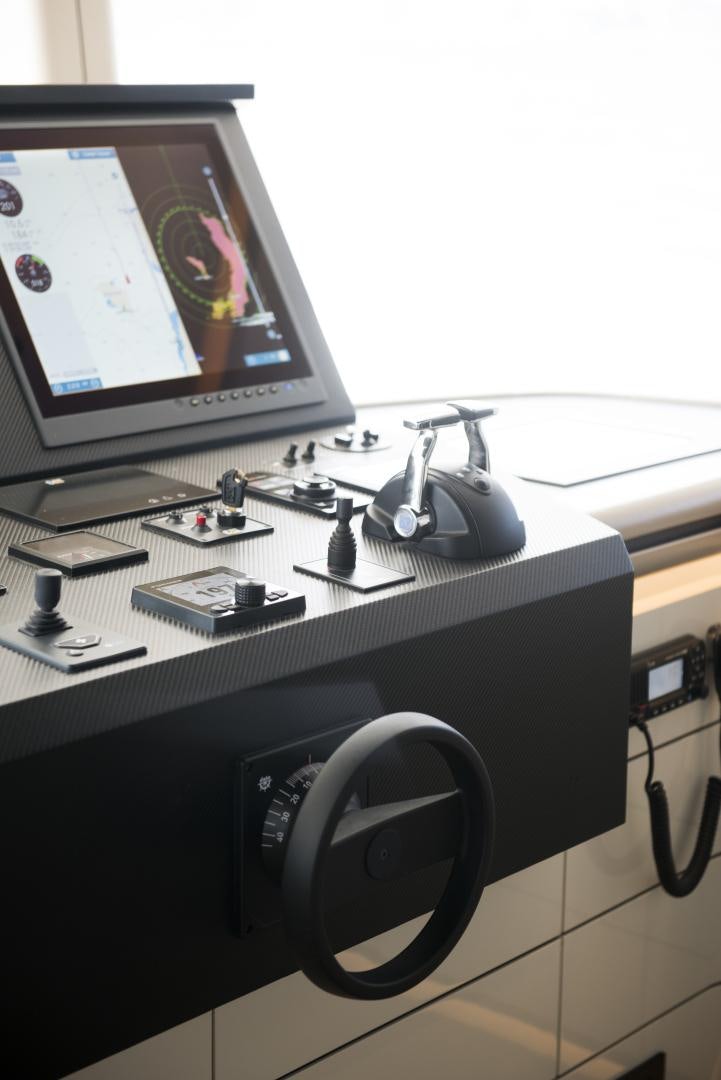 a black speaker next to a computer aboard ALFRESCO 125 Yacht for Sale