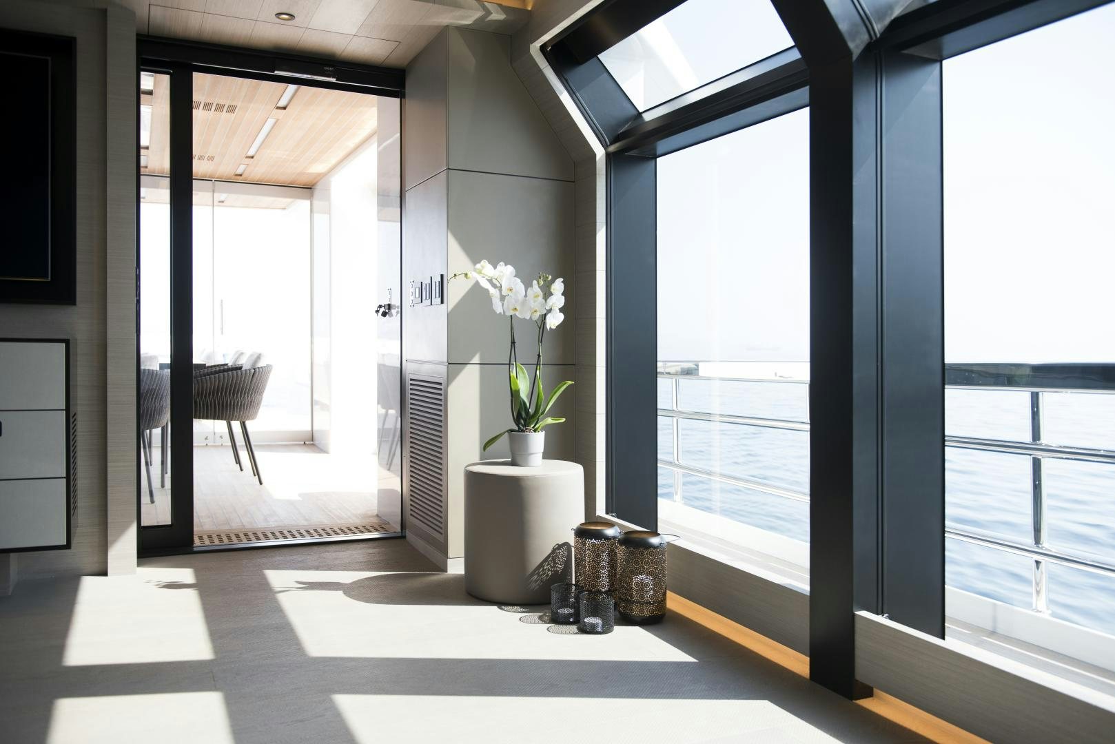 a room with a plant and windows aboard ALFRESCO 125 Yacht for Sale