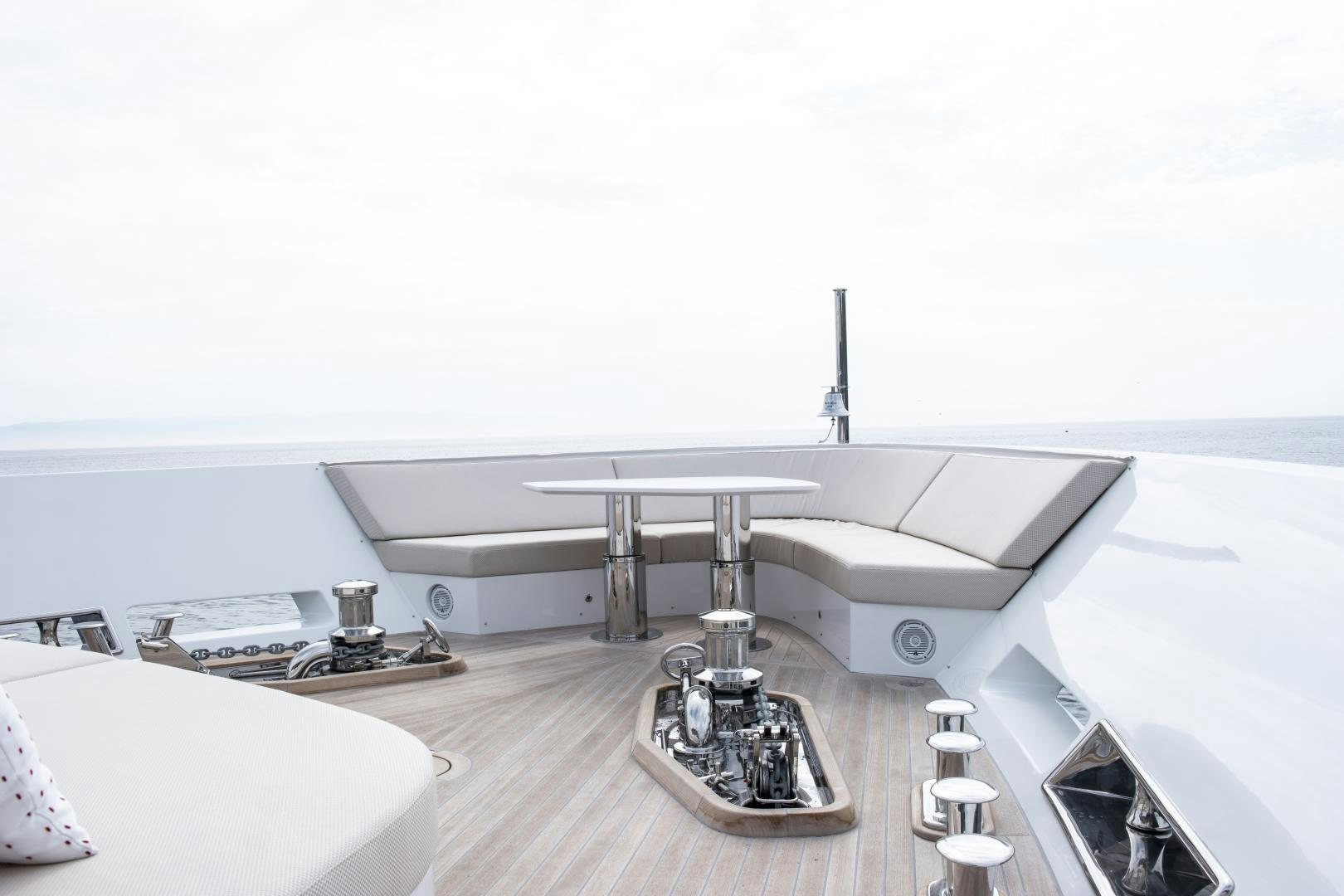 a large white table with a silver stand and a metal bar on it aboard ALFRESCO 125 Yacht for Sale