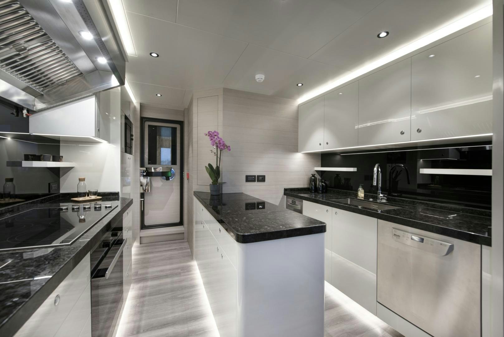 a kitchen with a large island aboard ALFRESCO 125 Yacht for Sale