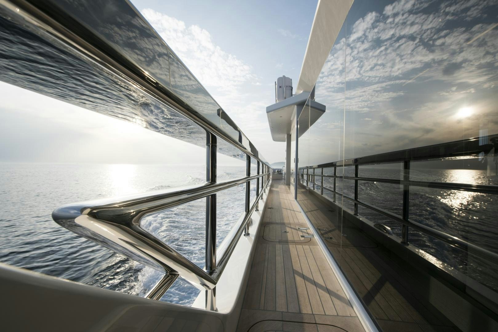 a deck with a railing and a building on the side aboard ALFRESCO 125 Yacht for Sale