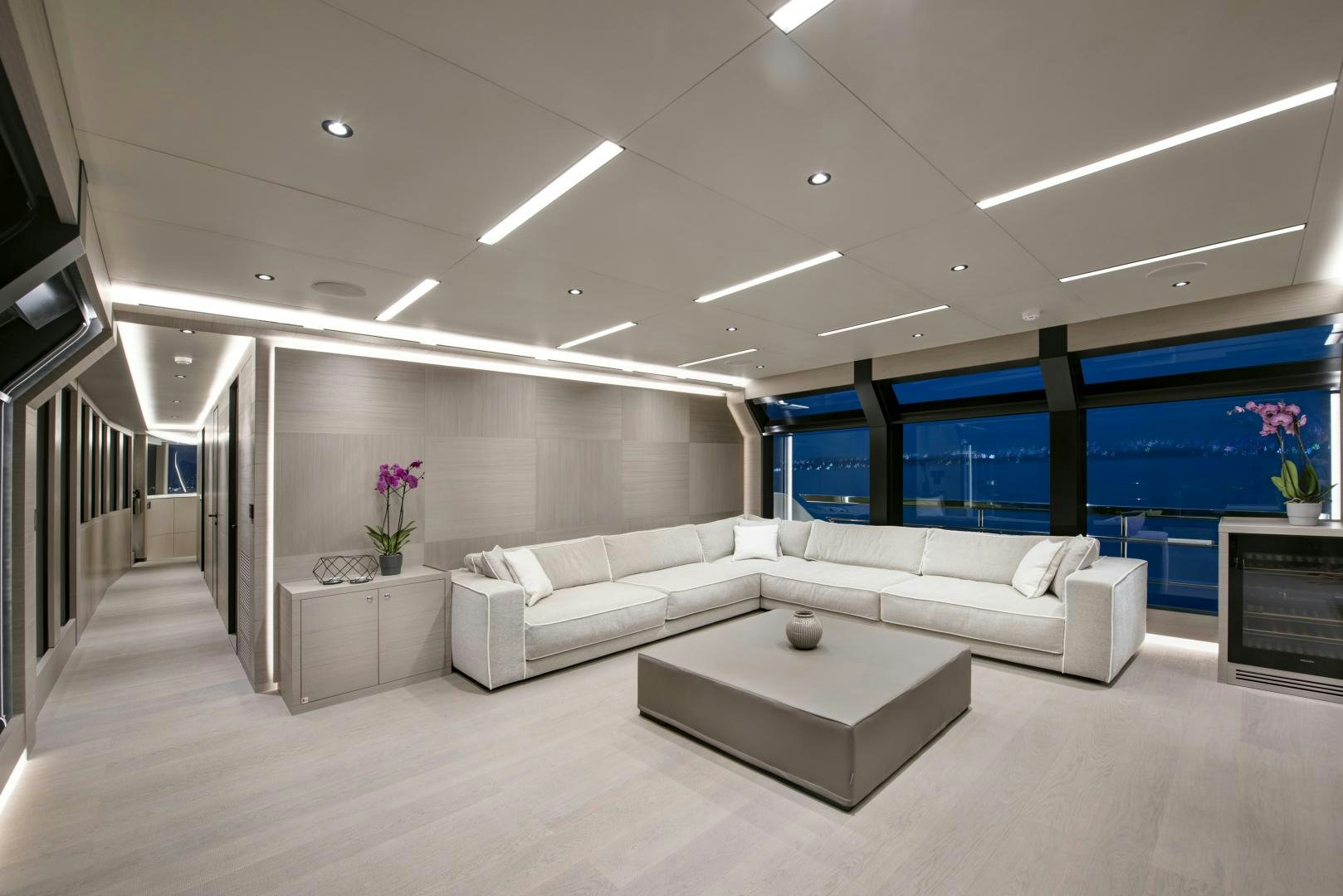 a room with white couches and a table aboard ALFRESCO 125 Yacht for Sale